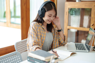 Self learning concept. Young woman student wear headphone listening audiobook technology education