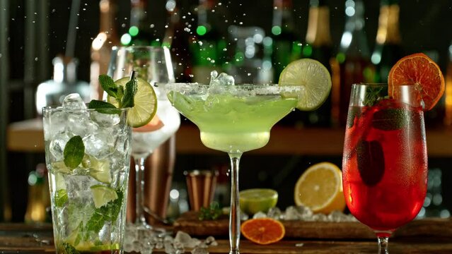 Super slow motion of preparing cocktails with speed motion. Filmed on high speed cinema camera, 1000 fps, placed on high speed cine bot. Bar with bottles on background. Speed ramp effect.