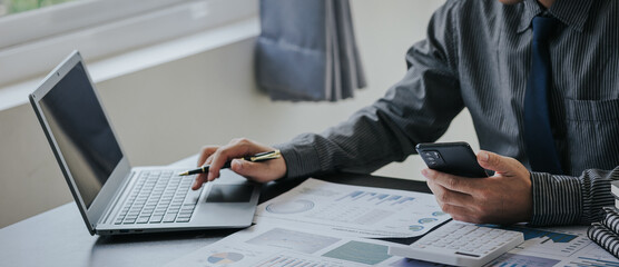 Business people in the office are examining financial reports for investment returns or investment risk analysis.