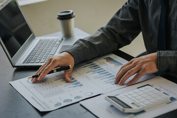 Business people in the office are examining financial reports for investment returns or investment risk analysis.