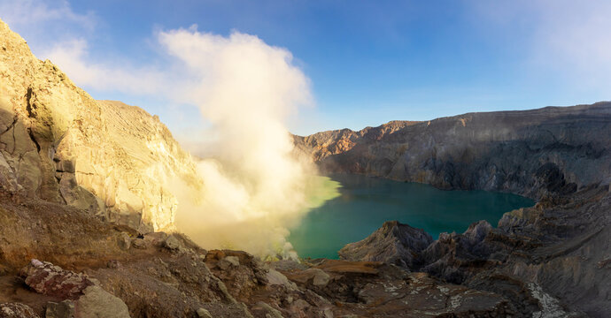 Beautiful landscape mountain and turquoise lake with smoke sulfur in the morning. The world's largest acidic lake,inside the crater of Kawah Ijen volcano in East Java, Indonesia. - Powered by Adobe