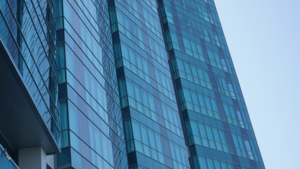 Fototapeta na wymiar low angle shot blue glass building with sky and cloud background. Skyscraper, view of modern business building. Sky view landscape with modern blue glasses building. looking up perspective. 