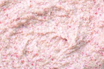 Creamy milk with pieces of fruit. Ice cream texture. Delicious sweet dessert close-up as a background.