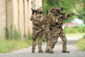 Special forces soldier in camouflage with a pair of weapons that are full of modern technology and complete for battle