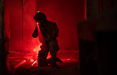 Fototapeta na wymiar Soldier in anti-terrorist warfare in a dark building, Anti-terrorist operation training on the battlefield