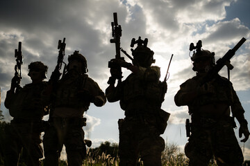 Soldier holding gun and showing action success or war win, special forces military training concept.
