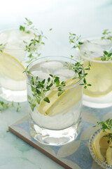 Glasses with lemon and thyme refreshing drink