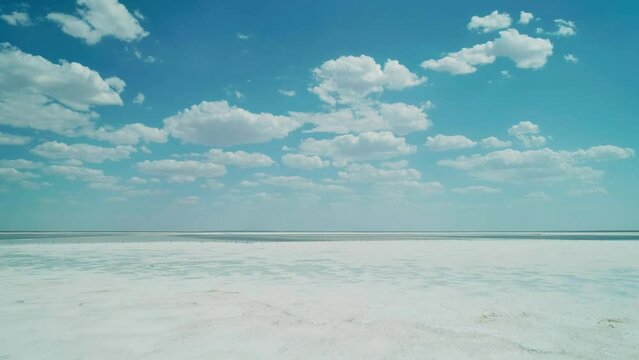 Aerial wide view of salt lake coast. Baskunchak in high tourist season at bright sunny day. Unique lake in the southwest of Russia, medicinal clay and mud deposite