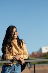 Fototapeta premium Happy and smiling woman walking through a city park