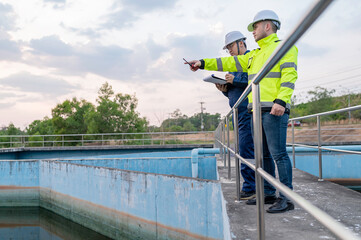 Environmental engineers work at wastewater treatment plants,Water supply engineering working at Water recycling plant for reuse,Technicians and engineers discuss work together.