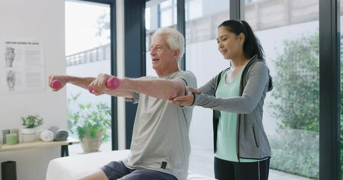 Support, dumbbell and physiotherapy with old man and woman in office for consulting, wellness or fitness. Rehabilitation, weightlifting and medical with senior patient and physiotherapist for health