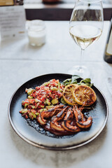 Close up shot of professionally prepared healthy delicious dish with fish and seafood.