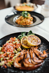 Close up shot of professionally prepared healthy delicious dish with fish and seafood.