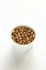 Carioca beans in a bowl on the white background.