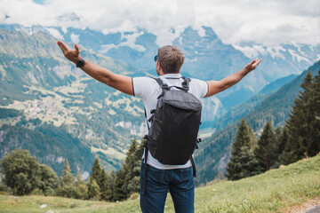 Young man hiking in Switzerland mountains