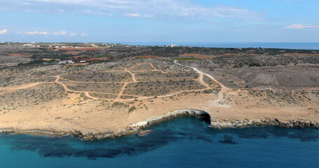 Copter flight over the high slope of the island with panoramic views of the city with houses, infrastructure and wildlife in Cyprus