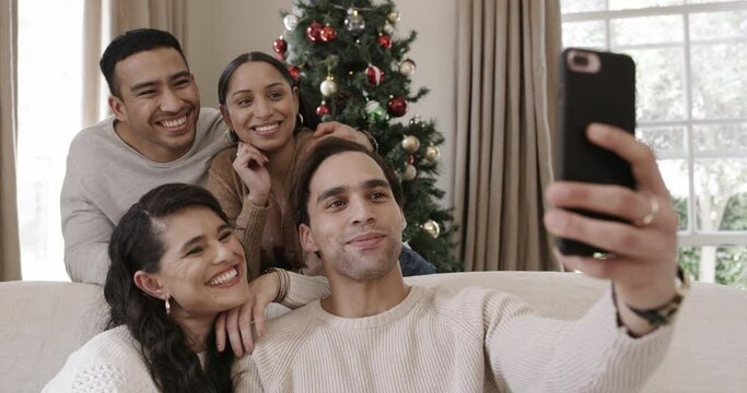 Friends, group and christmas selfie on sofa with smile, festive and happy in family home for blog. Men, women and photography with excited people, profile picture or post update on social media app