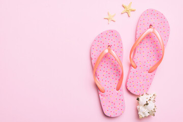 Flat lay composition with flip flops and seashell on colored background. Space for text top view