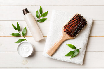 cosmetic for hair care, cream and towel on a colored background top view. flat lay