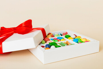 Valentine day composition: sweet candy, with gift boxes with bow and red felt hearts, photo template, background. Perspective View with copy space