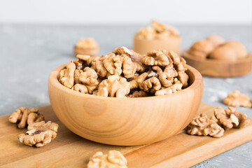 Fresh healthy walnuts in bowl on colored table background. Top view Healthy eating bertholletia concept. Super foods