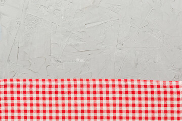 top view with red empty kitchen napkin isolated on table background. Folded cloth for mockup with...
