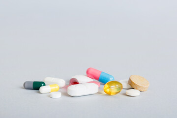 Many different colorful medication and pills perspective view. Set of many pills on colored...