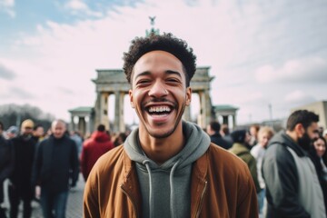 Young african american man in front of the famous Brandenburg Gate in Berlin