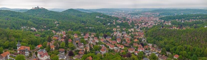 Drone panorama of thuringian city Eisenach with Wartburg castle during daytime - Powered by Adobe
