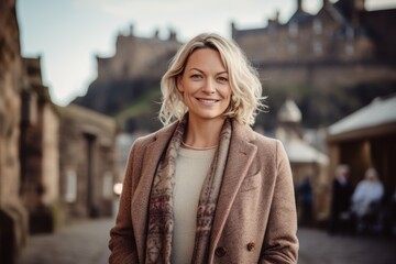 Fototapeta premium Portrait of a beautiful middle-aged woman smiling at the camera in Edinburgh, Scotland