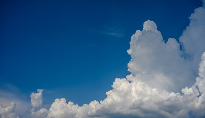 White, gray and bluish storm clouds building in a vividly blue sky. Room in the blue sky on the...