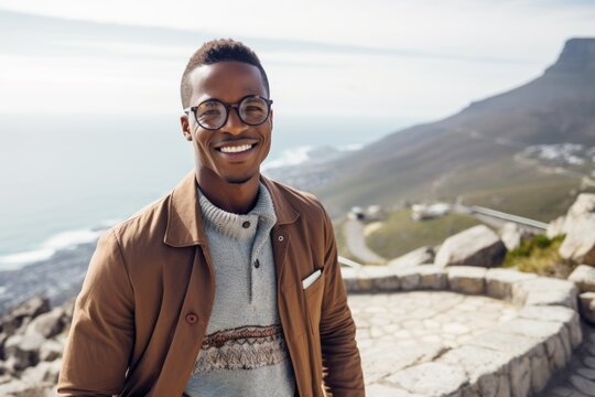 Group portrait photography of a pleased man in his 20s that is wearing a chic cardigan at the Table Mountain in Cape Town South Africa . Generative AI
