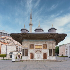 Fountain of Sultan Ahmed III, aka Ahmet Cesmesi, a 17th century public Turkish rococo water fountain, or Sabil, located in the Great Square, near the Imperial Gate of Topkapi Palace, Istanbul, Turkey