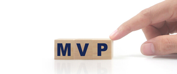 Wooden cube in hand with the letter from the mvp word
