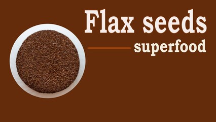 Flaxseeds Superfood text written with flax seeds in a blow in brown background. Flaxseeds are rich in omega 3 fatty acid . copy space
