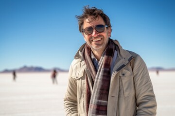 Fototapeta na wymiar Group portrait photography of a satisfied man in his 40s that is wearing a chic cardigan at the Salar de Uyuni in Potosi Bolivia . Generative AI
