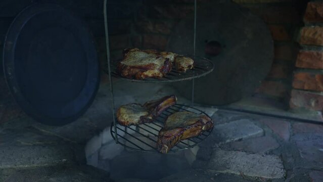 Cooking meat on the fire in the tandoori. Tasty barbecue in the tandoor, close up. Bbq outdoors in summer