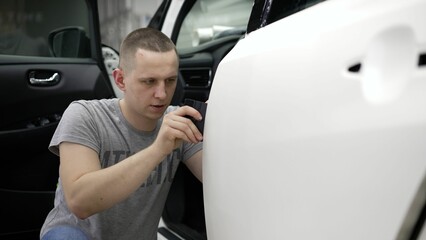 Retrofitting the car with a continuous protective film, the master makes a coating that protects...