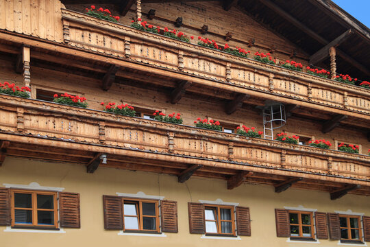 Traditional architecture from Tyrol - Austria. Close up from a wooden house with balcony and flower pots.