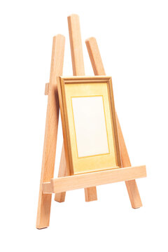Artist wooden easel with a wooden blank frame isolated on white