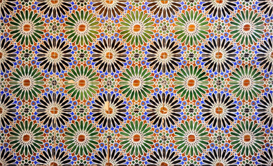 Tiles with a geometric design based on a twenty-pointed star. Decorative tile socle inside a house. Arabic style background. Talavera tiles. Spain