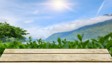 Blank wooden able with the view of plants and clear blue sky in sunshine day background for product display