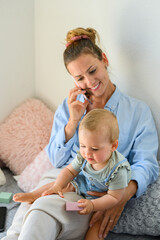 Content woman with kid having phone chat