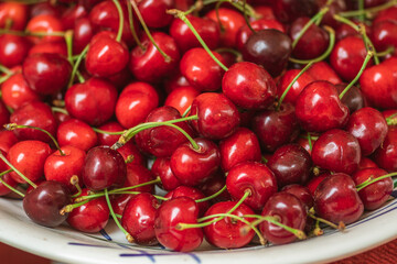 Fresh ripe red cherry or cherries fruit in a wooden box in a farmer agricultural open air market, seasonal healthy food. Concept of biological, bio products, bio ecology