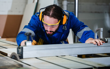 Carpenter worker doing his job in workshop. Technician handcrafted furniture in furniture factory. Construction site concept