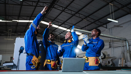 Team carpenter stack hand and shake hands to show success in workshop. Technician handcrafted furniture in furniture factory. Construction site concept.