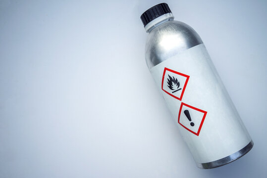 Metal bottle of dichloroethane on a white background.A canister with a poisonous substance.Dangerous glue vapors.Chemical burn.