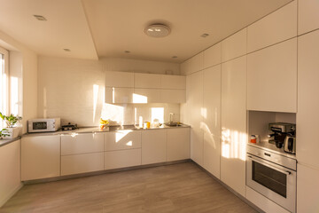 Modern white kitchen sink with morning sun rays
