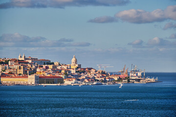 Fototapeta premium View of Lisbon over Tagus river from Almada with yachts tourist boats at sunset. Lisbon, Portugal