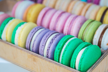 Yellow , pink, blue, orange macarons. Sweet French bakery  candy bar. Rainbow confectionary.